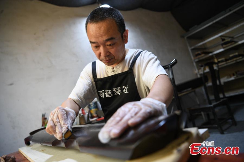 Mann verschreibt sich der traditionellen Guqin-Herstellung